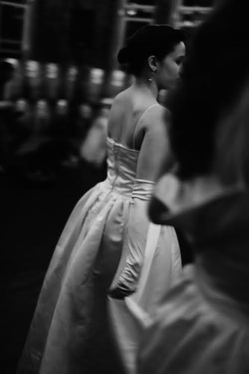 Side profile of dancer in gloves and gown waiting to go on stage